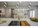 Modern kitchen island with stainless steel sink, stylish faucet, and contemporary lighting at 4395 Woodland Brook Se Dr, Atlanta, GA 30339