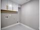 Functional laundry area with overhead cabinets, providing efficient storage and organization at 4395 Woodland Brook Se Dr, Atlanta, GA 30339