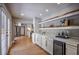 Living area with custom cabinets, white countertops, beverage fridge and hardwood flooring at 4395 Woodland Brook Se Dr, Atlanta, GA 30339