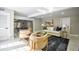 Open-concept living space with natural light, modern furniture, and view of a billiards table and staircase at 4395 Woodland Brook Se Dr, Atlanta, GA 30339