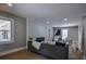 Open-concept living room with large windows, modern decor and cozy seating area with a brick accent wall at 4395 Woodland Brook Se Dr, Atlanta, GA 30339
