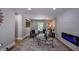 Comfortable living room featuring brick accent wall with an electric fireplace, and bright windows at 4395 Woodland Brook Se Dr, Atlanta, GA 30339