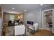 Bright living room with brick wall with fireplace, modern furniture, and view into game room with pool table at 4395 Woodland Brook Se Dr, Atlanta, GA 30339