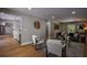 Inviting living room with hardwood floors, white armchairs, modern decor and large windows that provide natural light at 4395 Woodland Brook Se Dr, Atlanta, GA 30339