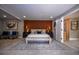 Luxurious main bedroom featuring an ensuite, gray walls, wooden accent wall, and neutral color palette at 4395 Woodland Brook Se Dr, Atlanta, GA 30339