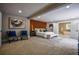 Stunning main bedroom featuring an ensuite bathroom, wooden accent wall, neutral color palette, and plush carpet at 4395 Woodland Brook Se Dr, Atlanta, GA 30339