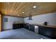 Modern outdoor kitchen with stainless steel appliances, butcher block countertops, and wood plank ceiling at 4395 Woodland Brook Se Dr, Atlanta, GA 30339