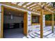 Stylish outdoor kitchen featuring wooden pergola, modern stainless steel appliances, and painted brick surround at 4395 Woodland Brook Se Dr, Atlanta, GA 30339