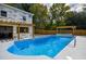 Backyard with a pool, lounge chairs, a wooden fence, a hot tub, and wooden pergola at 4395 Woodland Brook Se Dr, Atlanta, GA 30339
