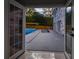 A view from inside the home showcasing the pool and outdoor lounge area for relaxation and entertaining at 4395 Woodland Brook Se Dr, Atlanta, GA 30339
