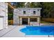 Pool with lounge chairs and pergola, set against a backdrop of verdant greenery at 4395 Woodland Brook Se Dr, Atlanta, GA 30339