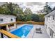Aerial view of an inground pool, pergolas, lounge chairs, privacy fence, and mature trees at 4395 Woodland Brook Se Dr, Atlanta, GA 30339