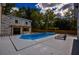 Backyard featuring a pool, hot tub, lounge chairs, wooden fence, and pergola at 4395 Woodland Brook Se Dr, Atlanta, GA 30339
