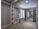 Large walk-in closet with open shelving, built-in drawers and a mirror at 4395 Woodland Brook Se Dr, Atlanta, GA 30339