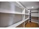 Empty walk-in closet with custom shelving and plenty of storage space at 4395 Woodland Brook Se Dr, Atlanta, GA 30339