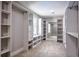 Spacious walk-in closet featuring open shelving, a built-in bench and a large mirror at 4395 Woodland Brook Se Dr, Atlanta, GA 30339