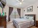 Serene bedroom with a gray comforter and large window at 3524 Beaver Swamp Rd, Loganville, GA 30052