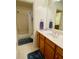 Bathroom with a shower/tub combo and wood vanity at 9801 Waters Edge Pointe, Villa Rica, GA 30180