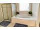 Relaxing bathroom featuring a jetted tub and walk-in shower at 9801 Waters Edge Pointe, Villa Rica, GA 30180