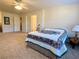 Bedroom with ceiling fan, carpet, and floral bedding at 9801 Waters Edge Pointe, Villa Rica, GA 30180