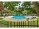Relaxing kidney-shaped pool with surrounding lounge area at 9801 Waters Edge Pointe, Villa Rica, GA 30180
