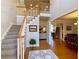 Two-story entry with hardwood floors, elegant staircase, and views to living and dining areas at 9801 Waters Edge Pointe, Villa Rica, GA 30180