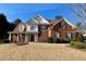 Brick two-story house with a large front yard and a columned porch at 9801 Waters Edge Pointe, Villa Rica, GA 30180