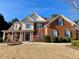 Brick two-story house with a welcoming front porch and landscaping at 9801 Waters Edge Pointe, Villa Rica, GA 30180
