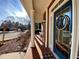 Inviting front porch with brick flooring, columns and a blue front door at 9801 Waters Edge Pointe, Villa Rica, GA 30180