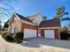 Two-car garage with a spacious driveway and brick exterior at 9801 Waters Edge Pointe, Villa Rica, GA 30180