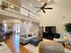 Open concept Gathering room with hardwood floors, fireplace, and high ceilings at 9801 Waters Edge Pointe, Villa Rica, GA 30180