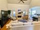 Open Gathering room with hardwood floors, fireplace, and access to sunroom at 9801 Waters Edge Pointe, Villa Rica, GA 30180