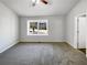 Main bedroom with carpet, ceiling fan, and large window at 2845 Robinson Wood Dr, Riverdale, GA 30296