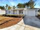 Ranch style home with gray siding, and attached garage at 2845 Robinson Wood Dr, Riverdale, GA 30296
