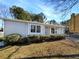 Gray sided ranch home with landscaped yard and driveway at 2845 Robinson Wood Dr, Riverdale, GA 30296