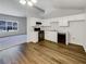 Eat-in kitchen features wood-look vinyl flooring and white cabinetry at 2845 Robinson Wood Dr, Riverdale, GA 30296