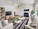Virtually staged living room with fireplace and large windows at 2845 Robinson Wood Dr, Riverdale, GA 30296