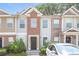 Brick front townhouse with a yellow door and a small yard at 2858 Vining Ridge Ter, Decatur, GA 30034