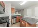 Kitchen boasting dark countertops, wood cabinets and stainless steel appliances at 2858 Vining Ridge Ter, Decatur, GA 30034