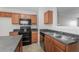 Kitchen with dark countertops, wood cabinets, and stainless steel appliances at 2858 Vining Ridge Ter, Decatur, GA 30034