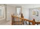 Upstairs hallway with wood railing and arched window at 1384 Carrington Way, Lawrenceville, GA 30044