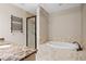 Bathroom with soaking tub and walk-in shower at 360 Chambers St # 204, Woodstock, GA 30188