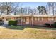 Brick ranch house with metal roof, landscaping, and a spacious yard at 4507 Dodson Dr, Douglasville, GA 30134