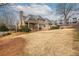 Large backyard featuring a spacious lawn, mature trees, and elegant brick detailing on the home's exterior at 1060 Morley Se Ave, Atlanta, GA 30312