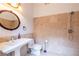 Bathroom features a pedestal sink, decorative mirror, and tiled shower with modern fixtures at 1060 Morley Se Ave, Atlanta, GA 30312