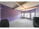 Spacious bedroom with purple walls, carpeting, and large windows at 1724 Stone Meadow Rd, Lithonia, GA 30058