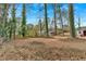 Large backyard with mature trees and a shed at 4223 Welbron Dr, Decatur, GA 30035