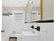 Clean bathroom with white tiled walls, a pedestal sink, and a bathtub at 4223 Welbron Dr, Decatur, GA 30035