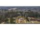 Aerial view of a charming home with a long driveway, lush trees, and a well-maintained yard at 3308 Wildwood Sw Dr, Marietta, GA 30060