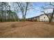 Expansive backyard with a wooden deck, mature trees and views of the home's exterior at 3308 Wildwood Sw Dr, Marietta, GA 30060